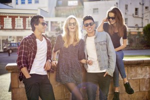 Group of 4 on Wall Smiling wearing Snaps sunglasses